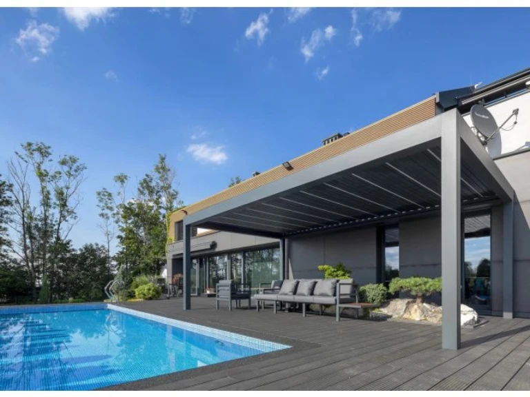 Moderní šedá bioklimatická pergola SUNBEAM 1400 na terase u bazénu s venkovním posezením